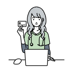 デスクで座ってPCを使いながらクレジットカードを手に持っている看護師の女性