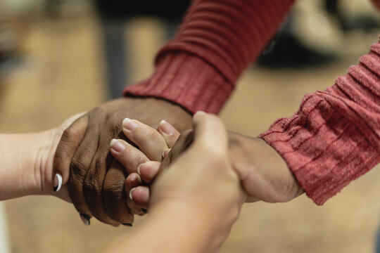 Two unrecognizable people holding hands