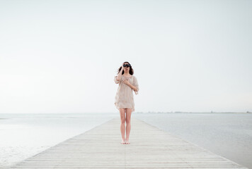 Standing woman using binoculars at dreamy scenery
