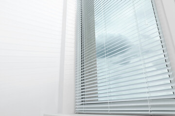 Fototapeta na wymiar Stylish window with horizontal blinds in room