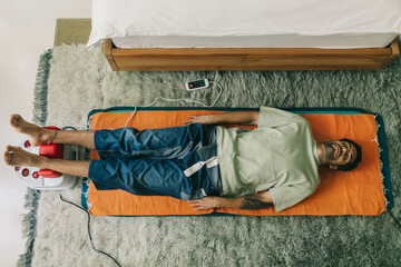 Young Man Relaxing Using A Medical Device