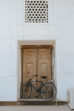 Black bicycle near old wooden door, Bukhara, Uzbekistan

