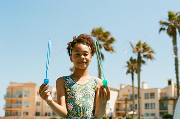 Girl with bubble wands