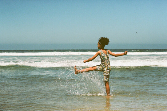 Girl splashing in ocean