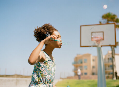 Girl blows bubbles