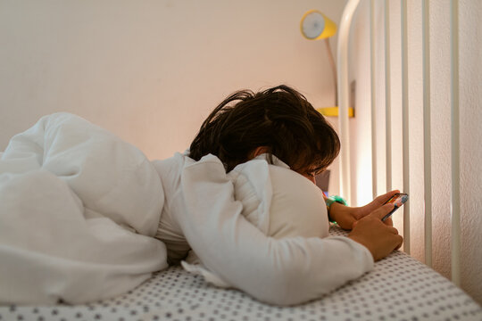 Teenager reading from bed