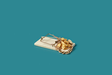 Mousetrap with gold nuggets and chain.