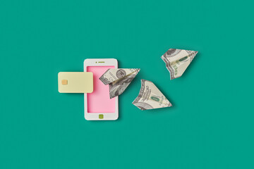 Smartphone with flying dollar paper planes.
