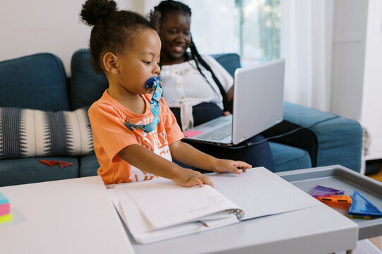 Woman working from home with a toddler