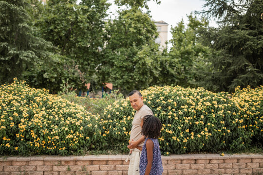multiracial family of father and daughter in the park outdoors