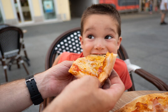 Happy child eating pizza for dinner