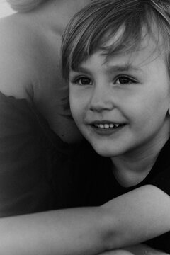 portrait of a little boy with in his mother's arms