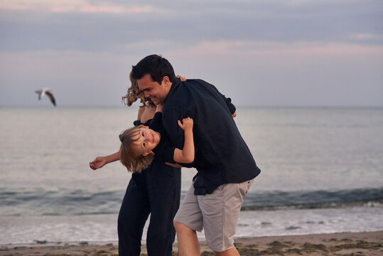 family playing near the sea