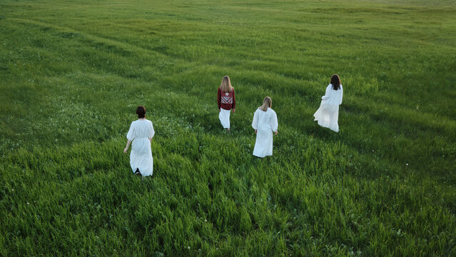 Women Walking Along Meadow