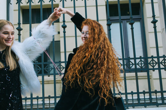 Red hair woman dancing with a friend