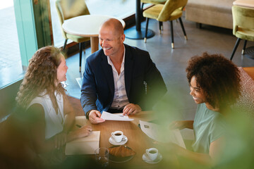 Multiracial HR manager discussing resumes of applicants