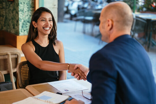 Happy candidate shaking hands with boss