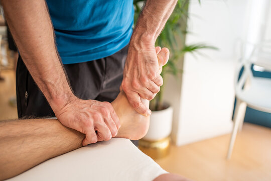 Detail Of A Physiotherapist Giving A Massage In A Clinic.