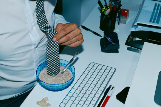 man has soaked accidentally his necktie in his breakfast bowl