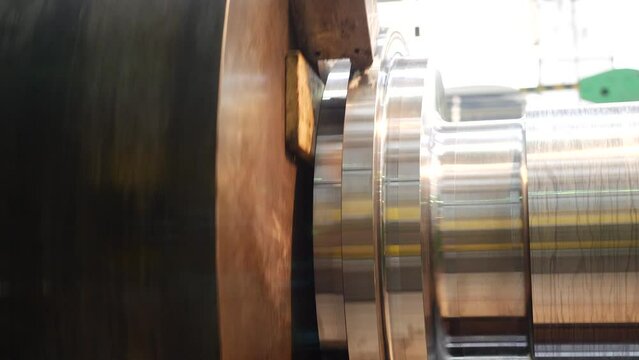 Cutting metal of rotor steam turbine at metalworking factory at workshop. Machine tool in metal plant with drilling cnc machines