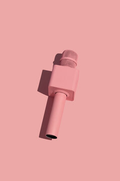 Pink microphone on pink background