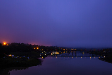 View of nature on the old wooden bridge in the morning in Thailand.