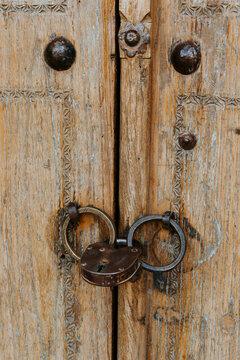 Old decorated wooden door with padlock