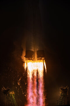 close-up shot of a rocket lift-off, bright flame