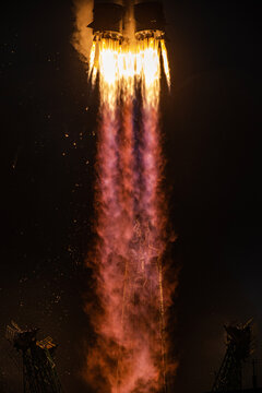 tele shot of a space rocket lift-off, bright flame