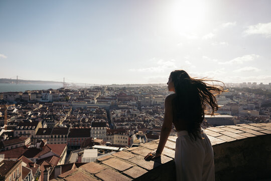 Young woman looking at the landscape of Lisbon