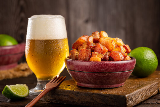 Pork rinds (torresmo) with beer, typical Brazilian food.