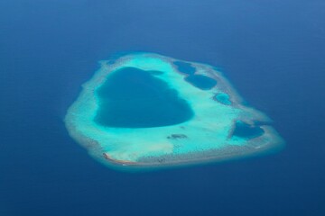 Areal view of small atoll reef in the Maldives 