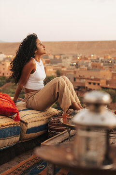 Moroccan girl drinking tea in a terrace