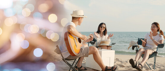 Happy friend have fun playing guitar and clap in camp they smiling together in holiday on sand...