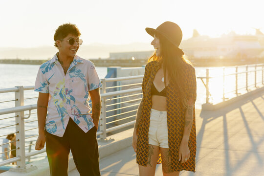 Two Friends Walk Along The Beach