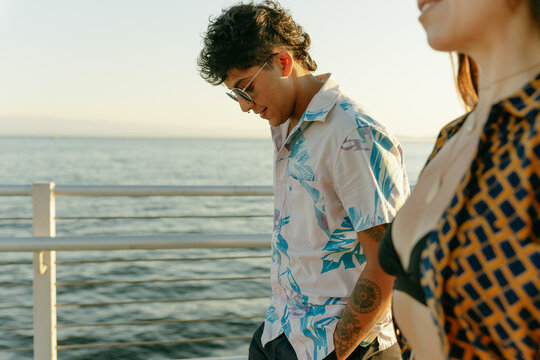 Two Friends Walk Along The Beach