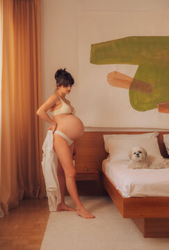 Fit pregnant woman with pet dog.