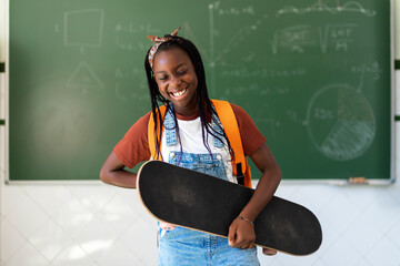 Portrait of Student holding a skateboard