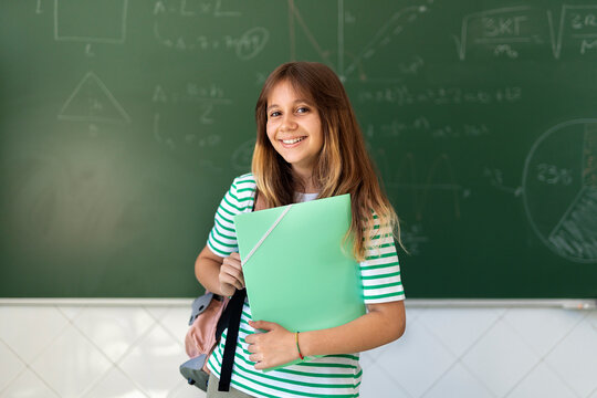 Young girl holding a binder
