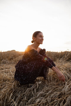 Girl enjoying spending time among harvest 