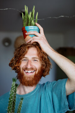 portrait of a man with a flower pot on his head