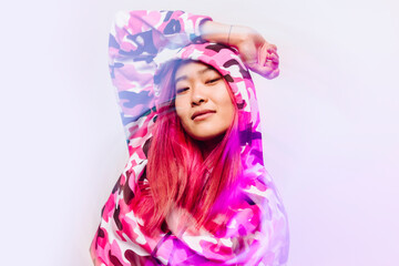 Cheerful chinese woman with colorful jacket looking at camera