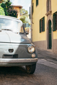 Tiny old car parked up in Tuscany.