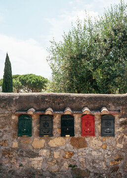 Row of mailboxes on a wall in Tuscany.