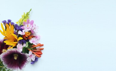 A summer bouquet with colorful flowers. A bright festive composition. Background for a greeting card.