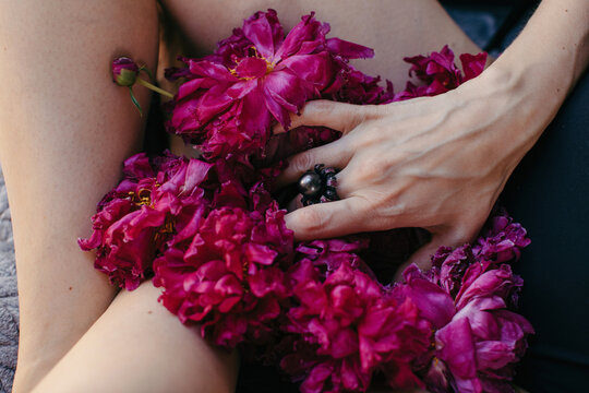 Crop lady touching bouquet of fresh and masturbating
