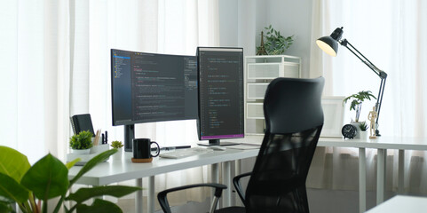 Software developer workplace with program code on wide displays. Coding, programming concept.