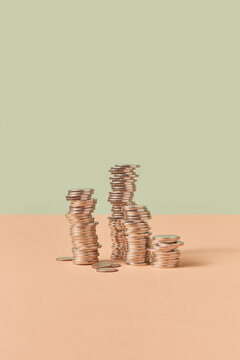 Stacks of cent coins on pastel background.