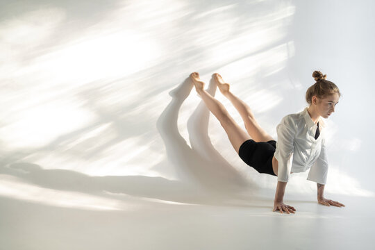 Female acrobat showing her capabilities in studio
