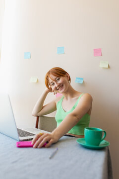 girl sitting at work and looking at the camera
